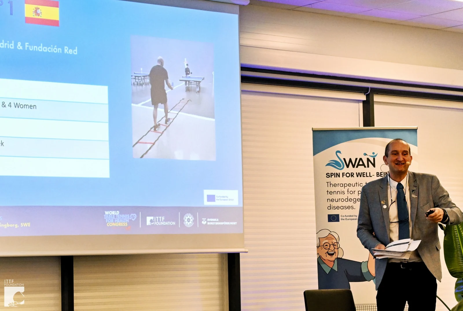 Ramon Ortega Montes presenting the Best Practices Report beside the SWAN banner