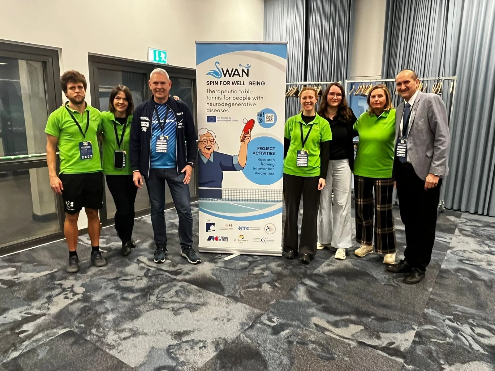 A second group of SWAN partners and participants beside the project banner