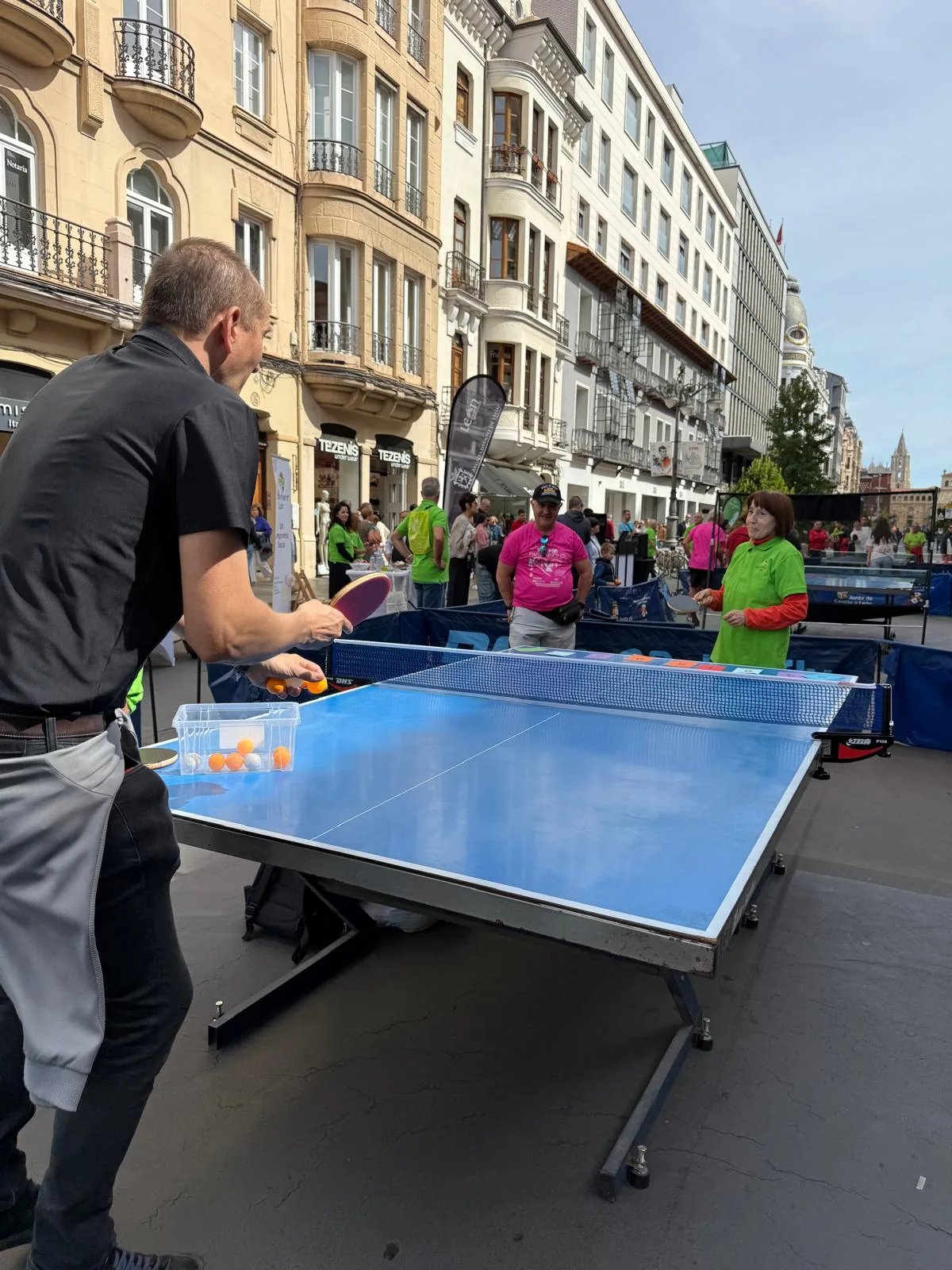 Two participants playing a rally at one of the open tables